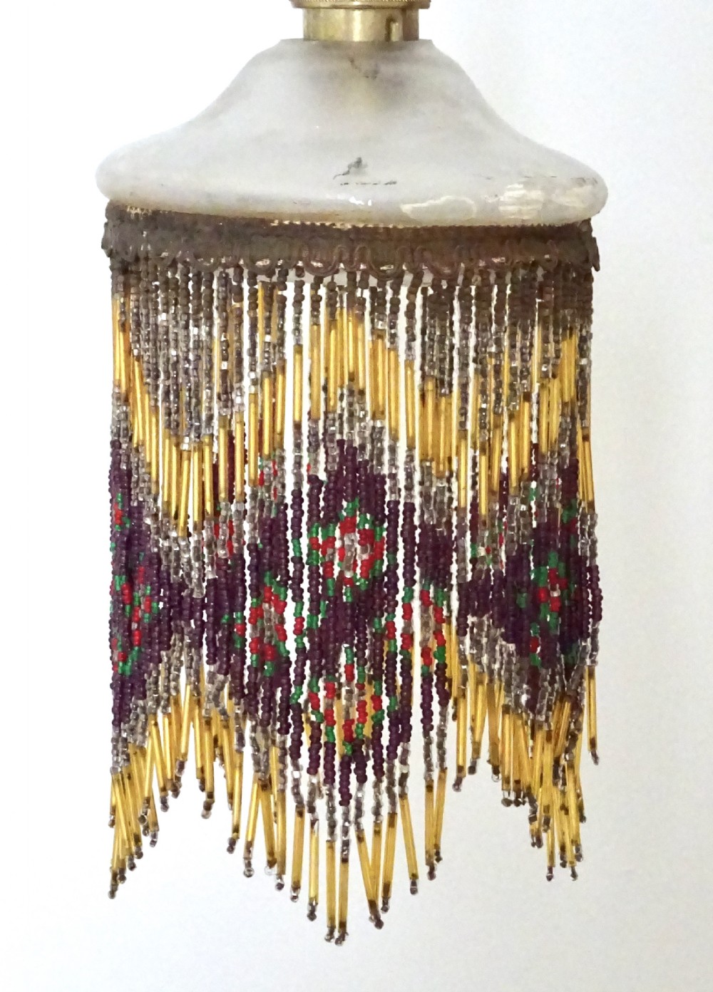 AN ORIGINAL BEADED LAMPSHADE WITH ORIGINAL OPAQUE GLASS TOP