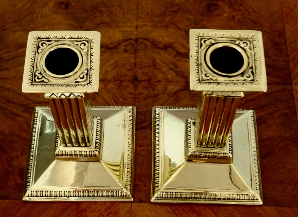 A PAIR OF  BRASS COLUMN CANDLESTICKS View V