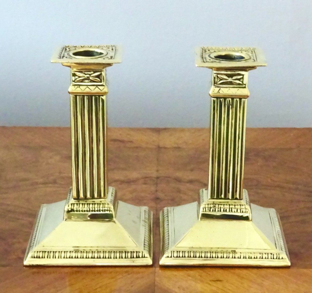 A PAIR OF  BRASS COLUMN CANDLESTICKS