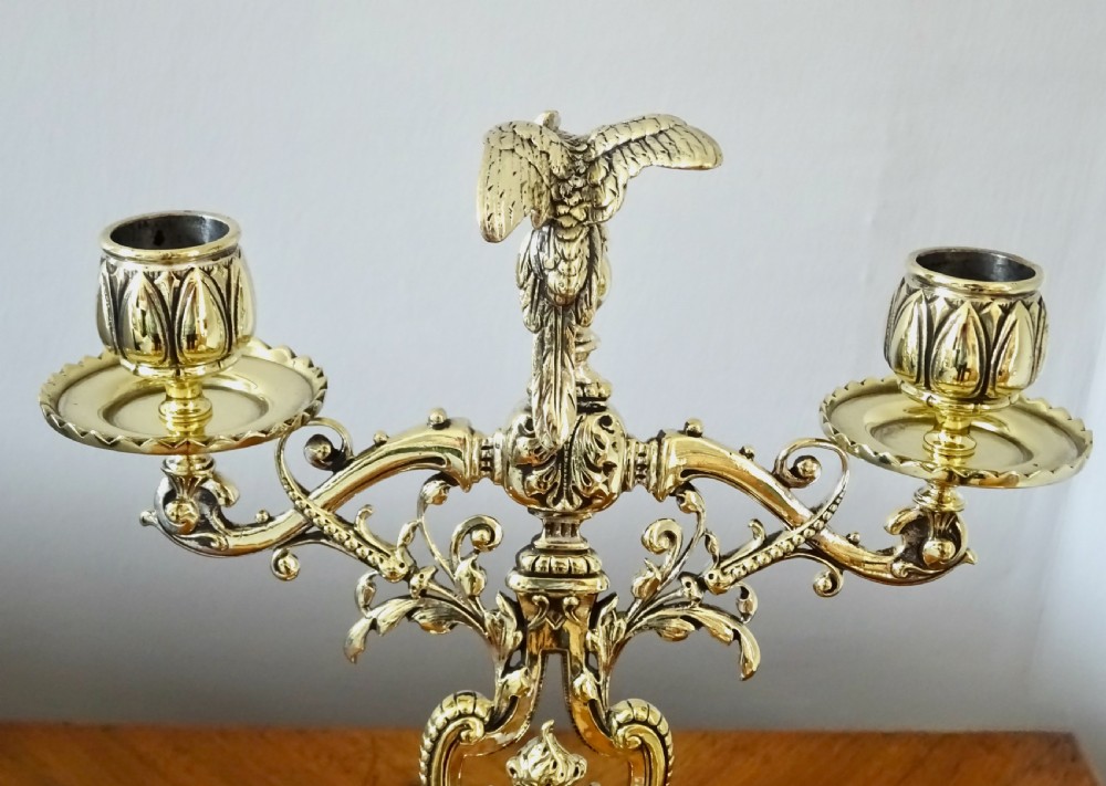 1887 - A BRASS CANDELABRA WITH A PARROT ON THE TOP View III
