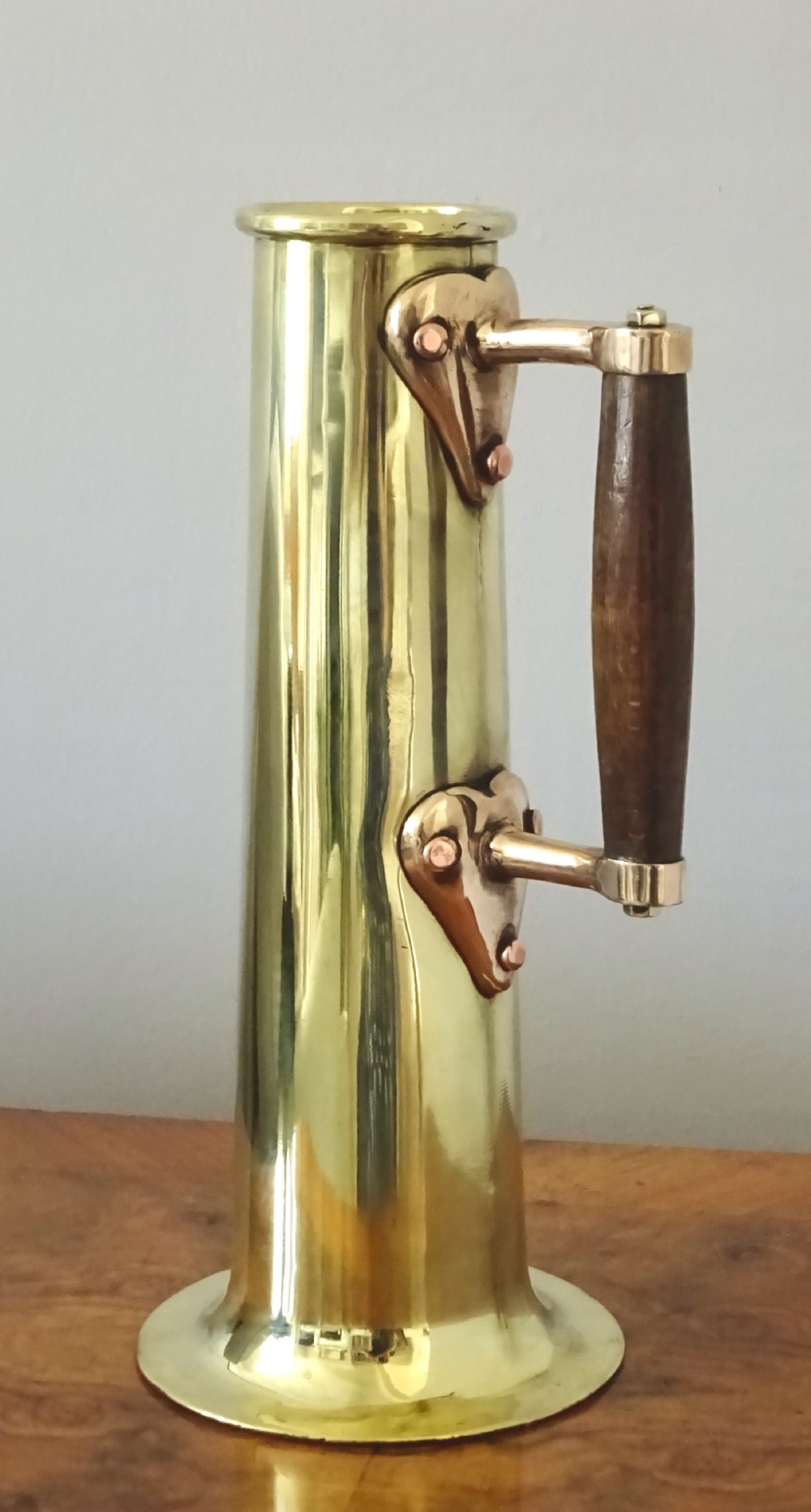 A BRASS AND BRONZE HYDROMETER JUG