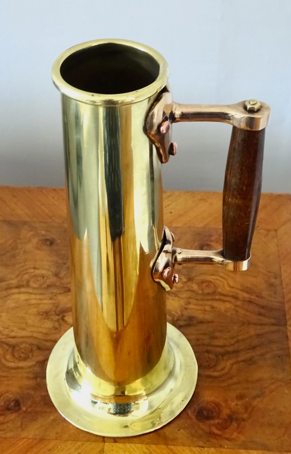 A BRASS AND BRONZE HYDROMETER JUG View II