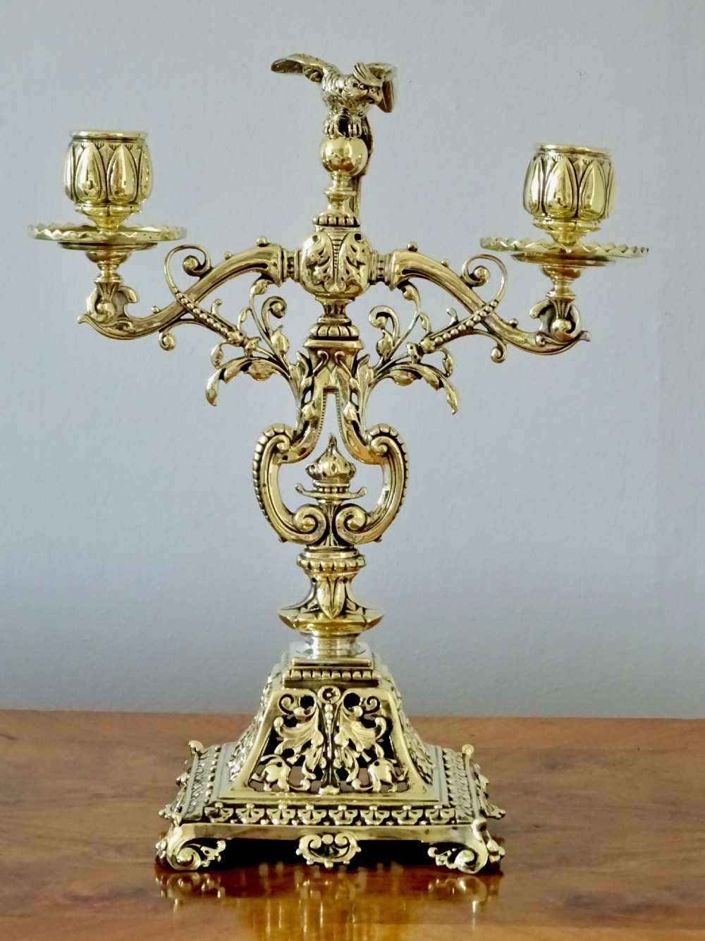 1887 - A BRASS CANDELABRA WITH A PARROT ON THE TOP View II