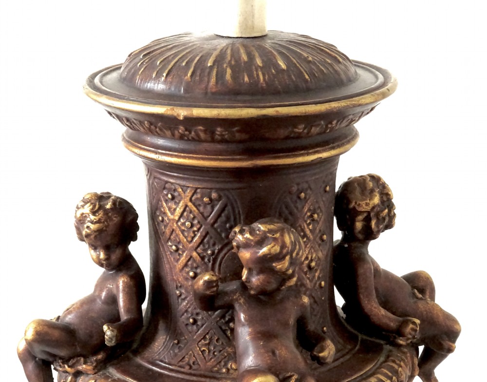 A cast metal Neoclassical table lamp base featuring sculpted cherubs and dolphin motifs mounted on a round onyx plinth. View VII