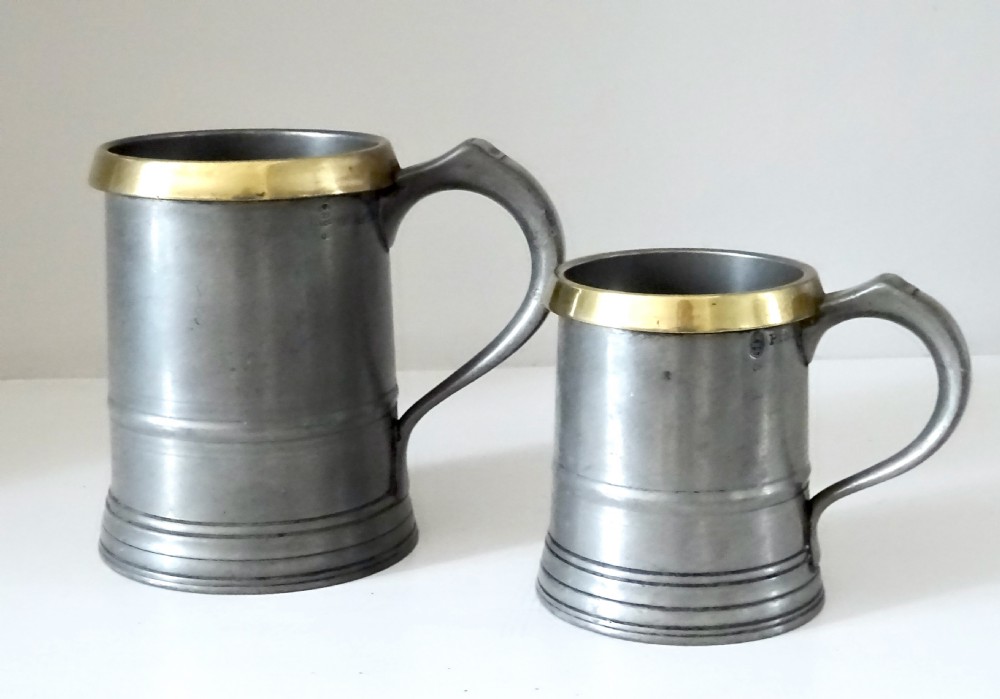 TWO LOFTUS PEWTER TANKARDS WITH BRASS RIMS