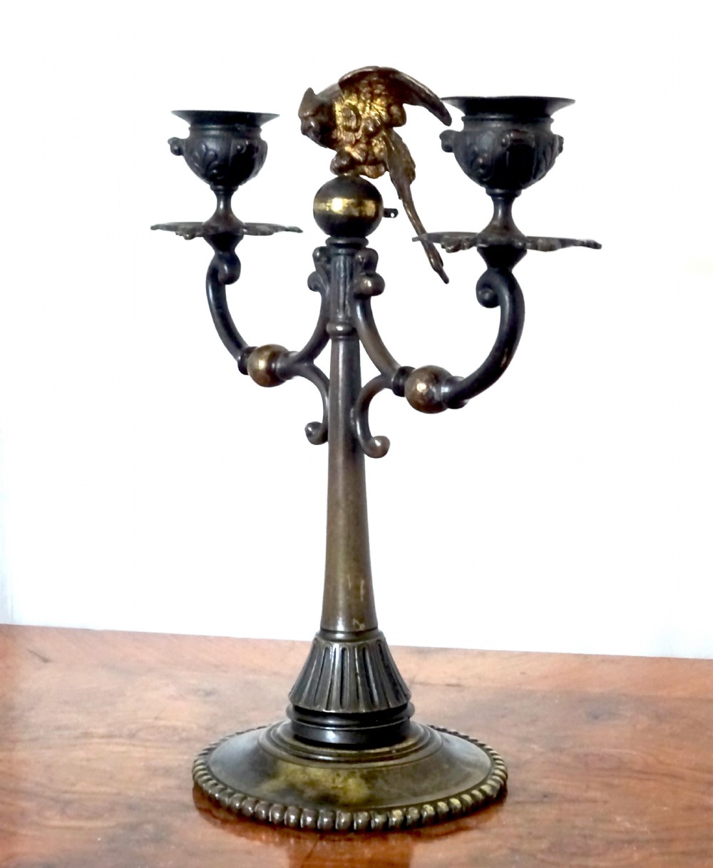 BRONZE CANDLESTICK WITH A PARROT ON THE TOP