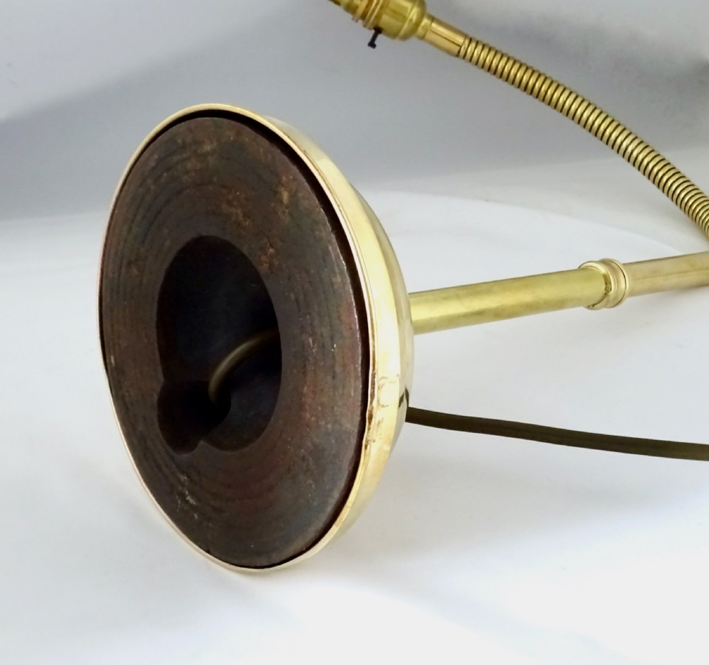 An antique polished brass task lamp featuring a heavy stepped circular base, a flexible gooseneck arm, and a brass bulb socket. View VI