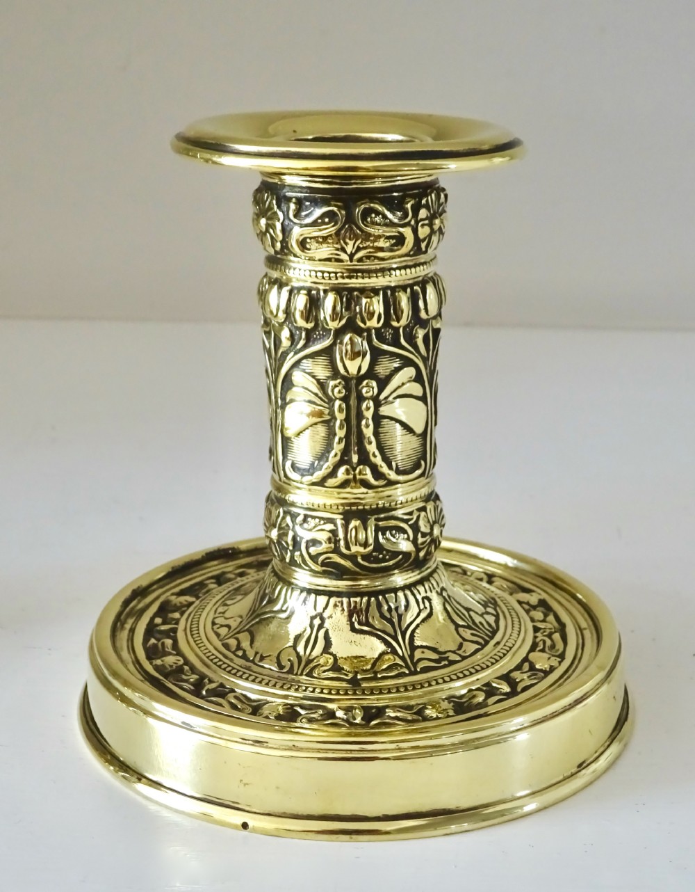 A PAIR OF SMALL DECORATIVE BRASS CANDLESTICKS View II