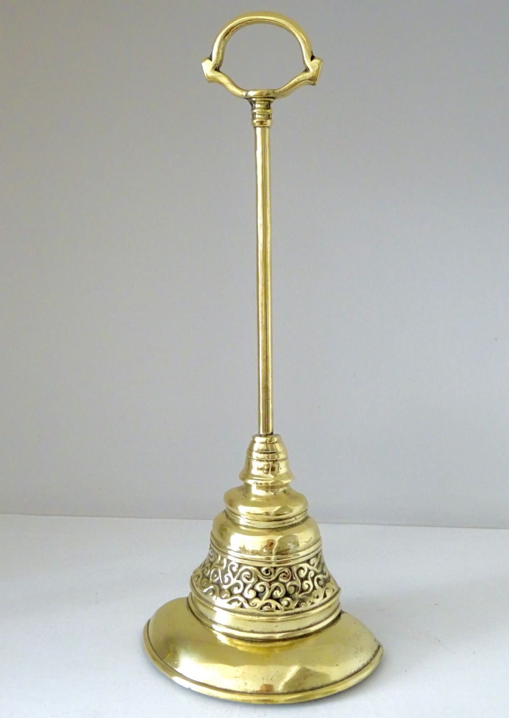 A TALL BRASS DOORSTOP