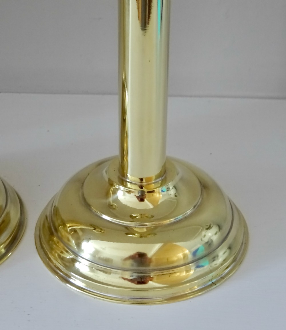 A pair of polished gold brass Victorian candle lamps featuring tall columnar stems, stepped circular bases, and pierced crown shade holders. View IV