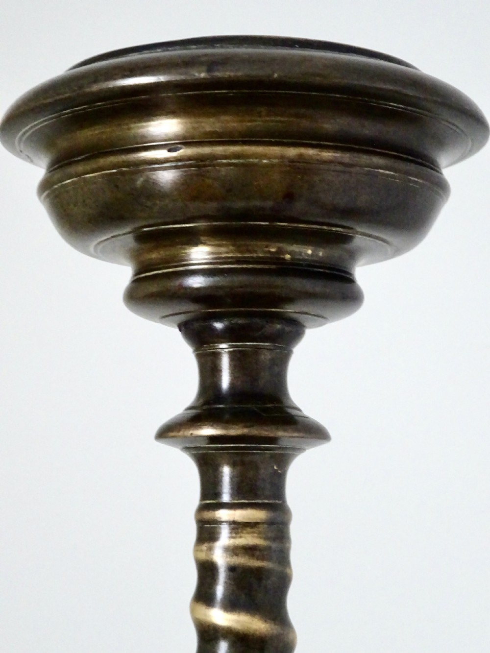 A tall, cast bronze candlestick featuring a turned spiral stem, wide sconce, and ornate claw-footed tripod base. View VI