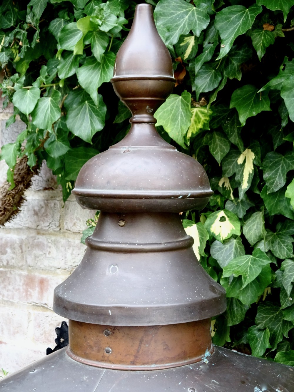 A late Victorian copper street lantern featuring a tiered cap with a finial, clear glass panels tapering downwards, and a black patinated frame. View IV