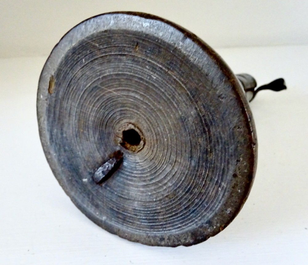 An antique 19th-century iron spiral candlestick with a top hanging hook and internal slider, set into a turned dark wood base. View V