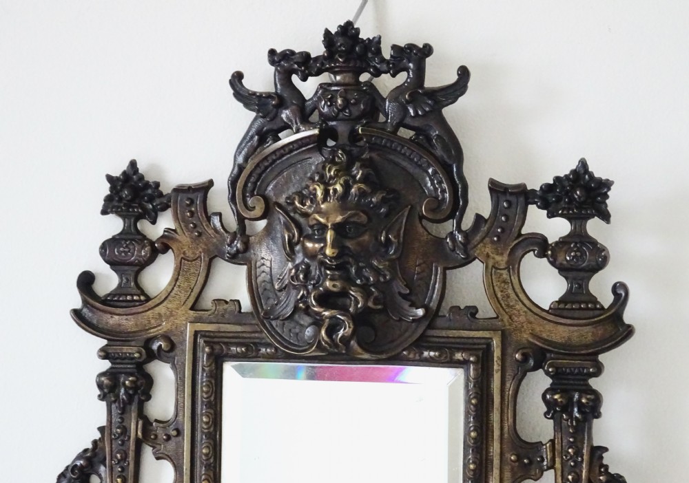 A pair of cast bronze girandole wall sconces featuring rectangular mirrors, three candle branches, and decorative scrollwork frames topped with carved mascaron masks. View II