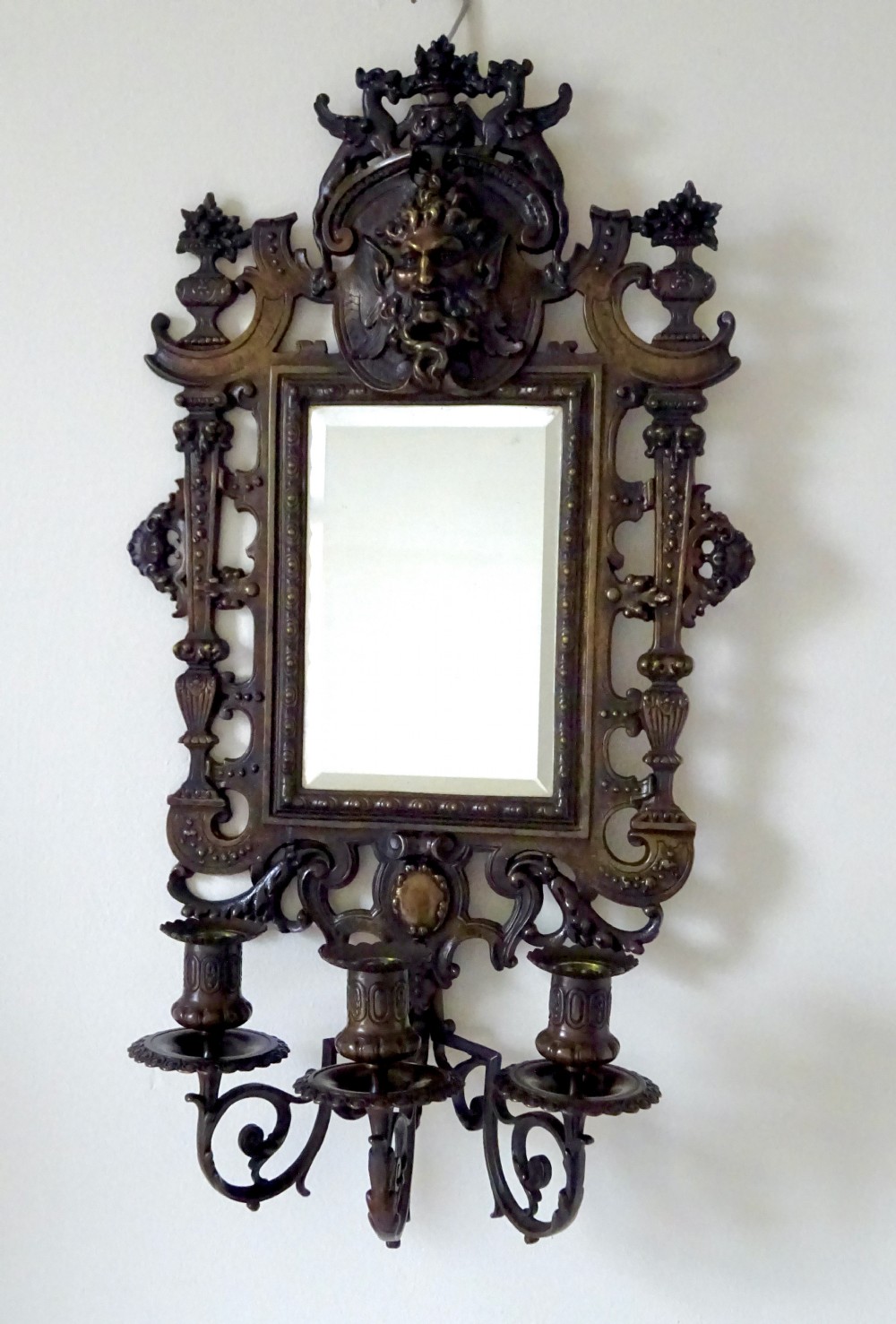 A pair of cast bronze girandole wall sconces featuring rectangular mirrors, three candle branches, and decorative scrollwork frames topped with carved mascaron masks. View XI