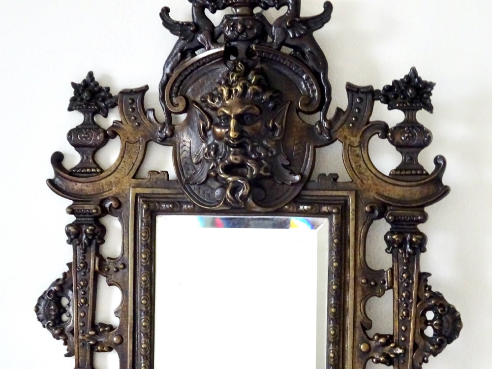 A pair of cast bronze girandole wall sconces featuring rectangular mirrors, three candle branches, and decorative scrollwork frames topped with carved mascaron masks. View IX