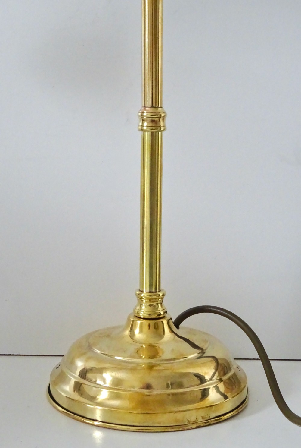 An antique polished brass task lamp featuring a heavy stepped circular base, a flexible gooseneck arm, and a brass bulb socket. View III
