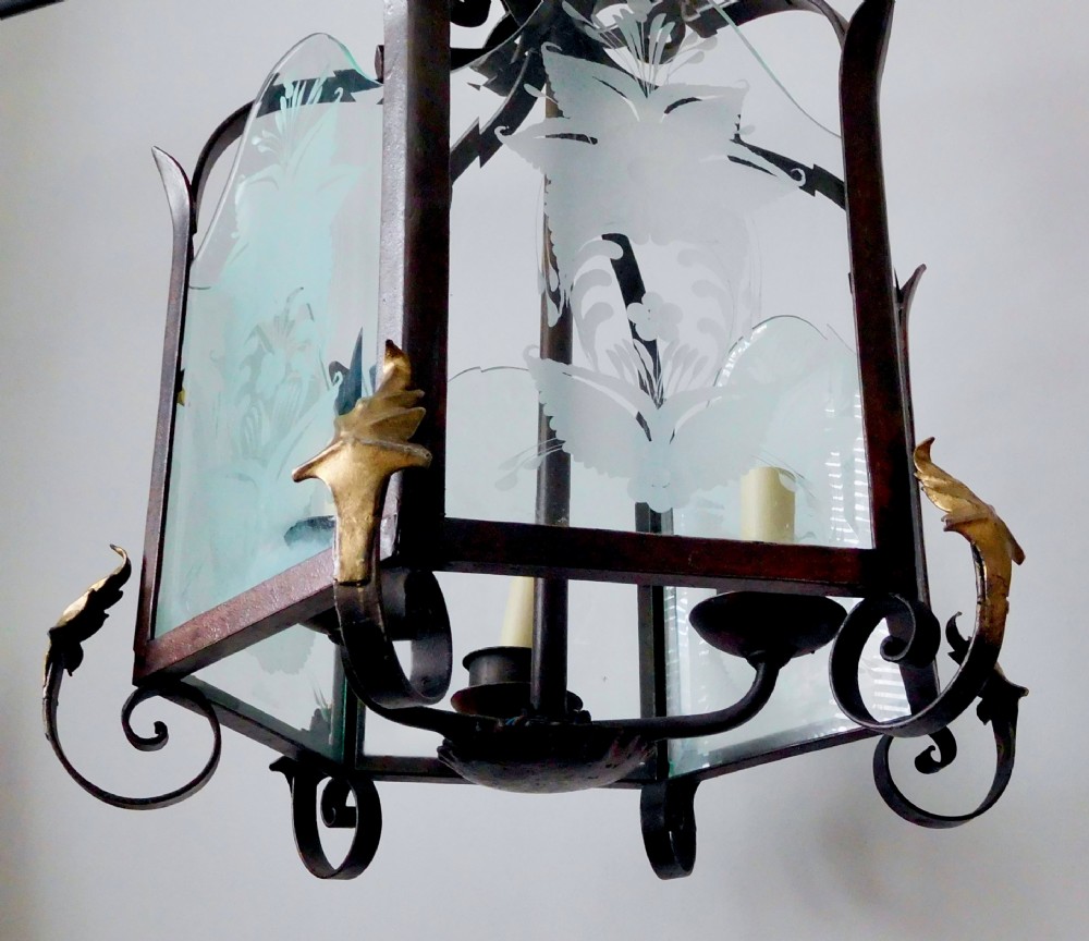 A late 19th-century hanging wrought iron hall lantern featuring etched glass panels with botanical motifs and gilt leaf accents. View V