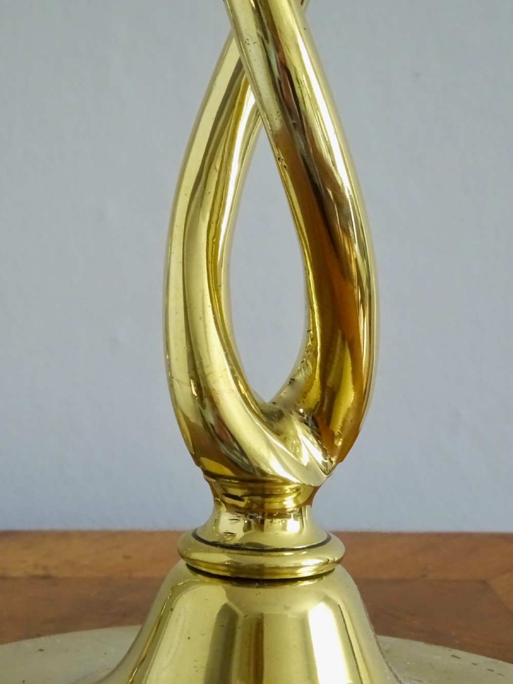 A pair of polished gold brass candlesticks featuring open-twist stems resting on circular bases. View VI