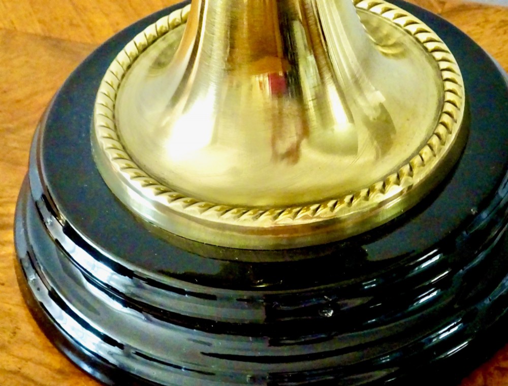 An antique brass oil lamp featuring a hand-painted floral glass font, a frosted etched globe shade, and a tall clear glass chimney on a stepped circular base. View VI