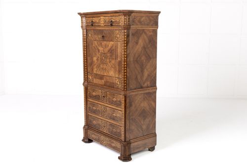 fig 1. A tall nineteenth-century Italian secretaire cabinet featuring geometric marquetry veneer, a drop-front fall, and stacked drawers.