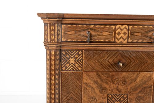 fig 2. A tall nineteenth-century Italian secretaire cabinet featuring geometric marquetry veneer, a drop-front fall, and stacked drawers.