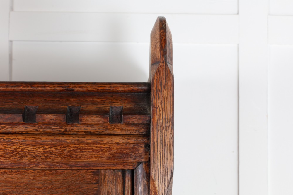 A tall nineteenth-century solid oak glazed bookcase featuring upper glass doors, four central drawers, and lower cupboard doors with carved linenfold panels. View X