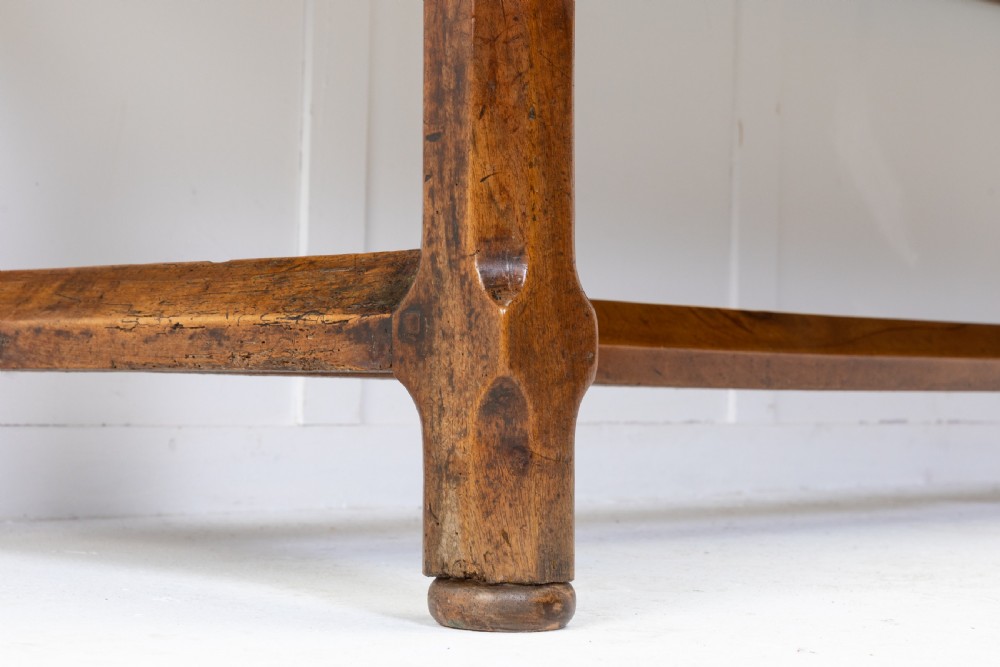 An elongated nineteenth-century French walnut serving table featuring a plank top, two front drawers with small brass knobs, and sturdy legs connected by a low stretcher base. View IV