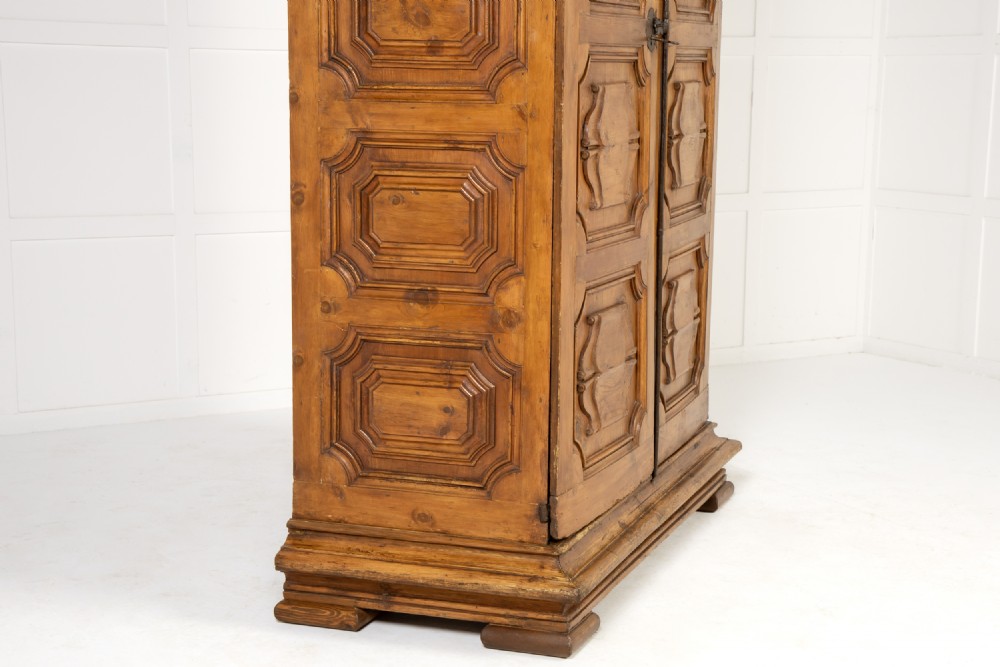 An eighteenth-century Italian pine armoire featuring an arched pediment, double doors with raised moulded panels, and wrought iron lock hardware. View X