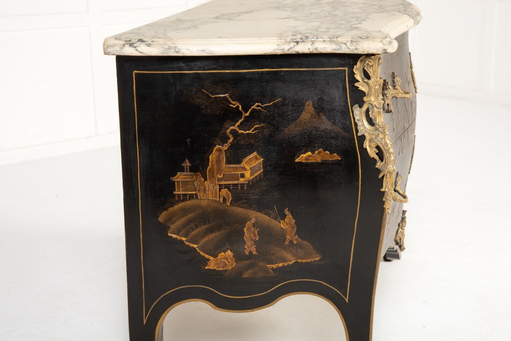 A French Louis XV style bombe commode featuring black japanned lacquer with detailed gold Chinoiserie landscapes, a shaped marble top, and gilt bronze mounts. View IV