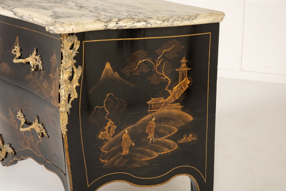 A French Louis XV style bombe commode featuring black japanned lacquer with detailed gold Chinoiserie landscapes, a shaped marble top, and gilt bronze mounts. View V