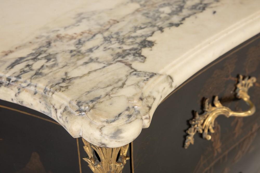 A French Louis XV style bombe commode featuring black japanned lacquer with detailed gold Chinoiserie landscapes, a shaped marble top, and gilt bronze mounts. View VI