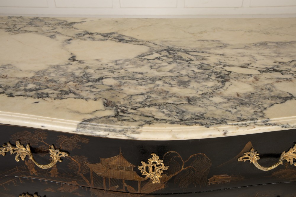 A French Louis XV style bombe commode featuring black japanned lacquer with detailed gold Chinoiserie landscapes, a shaped marble top, and gilt bronze mounts. View VII