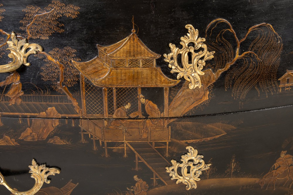 A French Louis XV style bombe commode featuring black japanned lacquer with detailed gold Chinoiserie landscapes, a shaped marble top, and gilt bronze mounts. View VIII