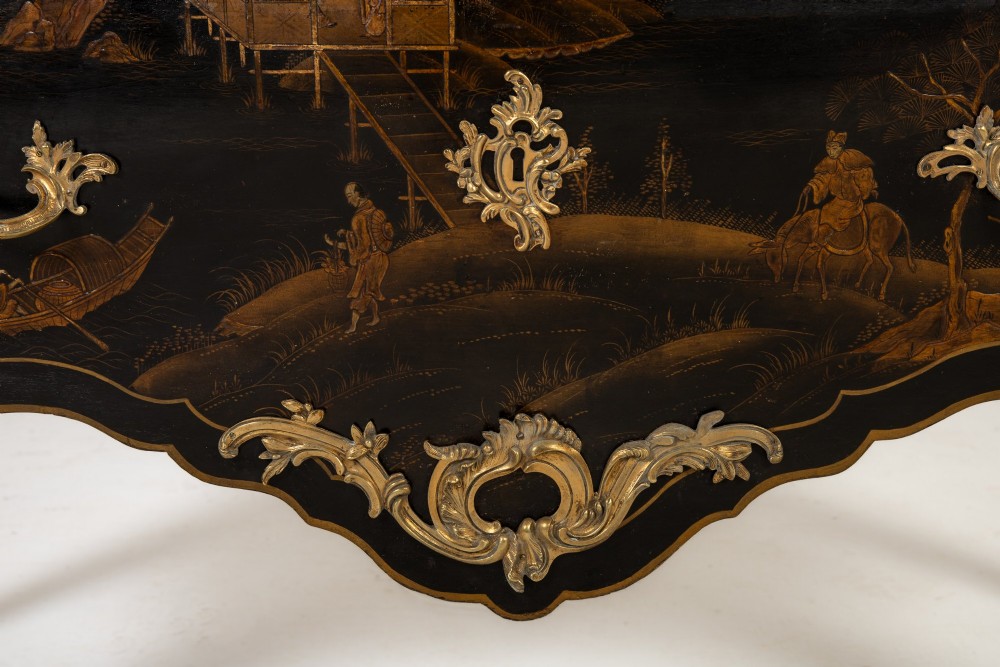 A French Louis XV style bombe commode featuring black japanned lacquer with detailed gold Chinoiserie landscapes, a shaped marble top, and gilt bronze mounts. View IX