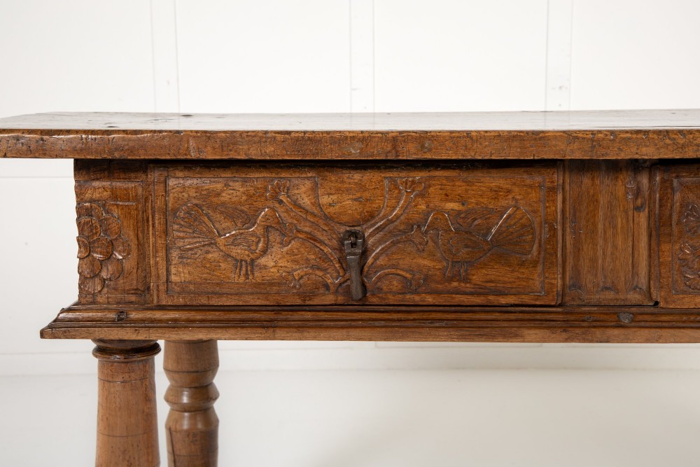 A 17th-century Spanish walnut side table featuring three carved drawer fronts, turned legs, and a low stretcher base. View III