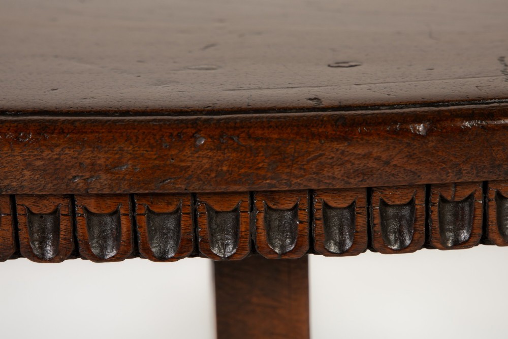 A pair of 18th-century Italian walnut demi-lune console tables with carved dentil edges, shaped legs, and central stretchers. View III