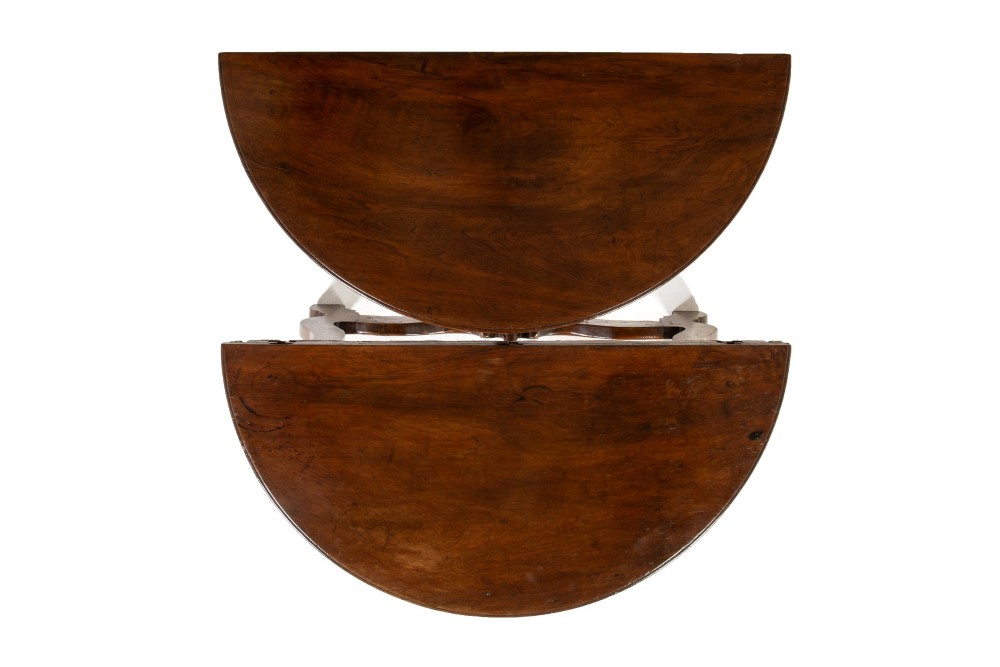 A pair of 18th-century Italian walnut demi-lune console tables with carved dentil edges, shaped legs, and central stretchers. View VI