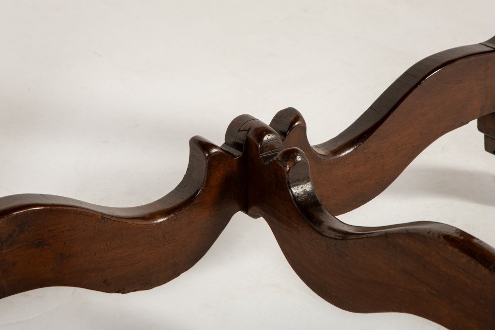 A pair of 18th-century Italian walnut demi-lune console tables with carved dentil edges, shaped legs, and central stretchers. View VIII