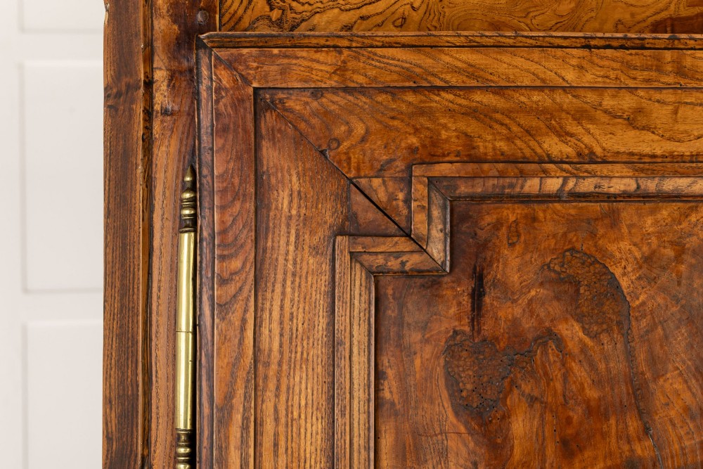 An 18th-century French ash buffet deux corps featuring two upper panelled doors, two lower doors, and carved apron details. View VIII