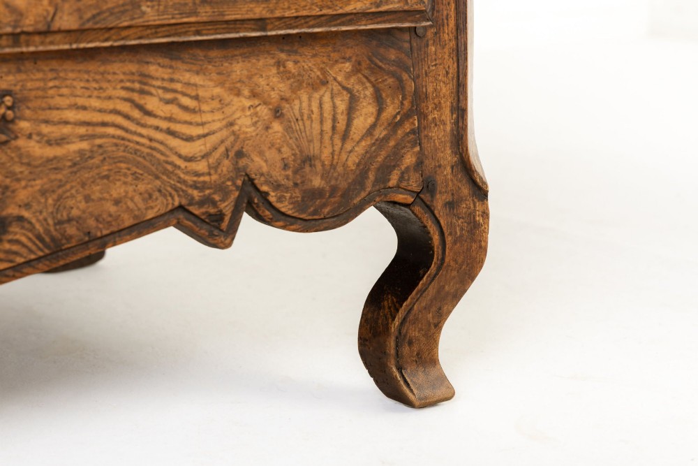 An 18th-century French ash buffet deux corps featuring two upper panelled doors, two lower doors, and carved apron details. View XI