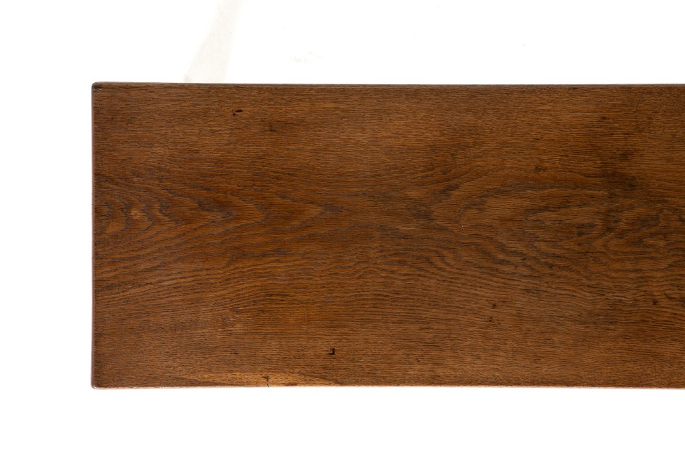 A long 19th-century dark oak bench featuring a rectangular plank seat supported by turned legs with fluted frieze details. View V
