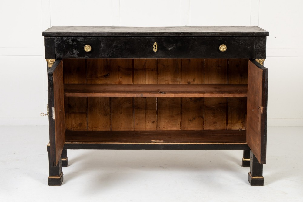 A pair of matching 18th-century Italian ebonised side cabinets featuring gilt metal mounts, fluted corner columns, single top drawers, and double panelled doors. View III