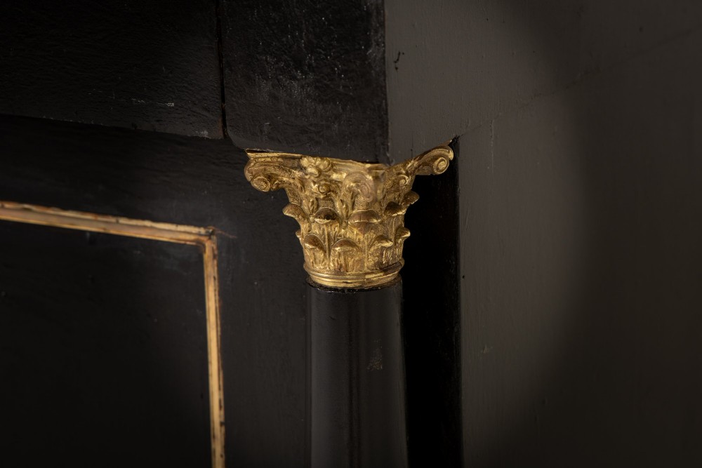 A pair of matching 18th-century Italian ebonised side cabinets featuring gilt metal mounts, fluted corner columns, single top drawers, and double panelled doors. View IV