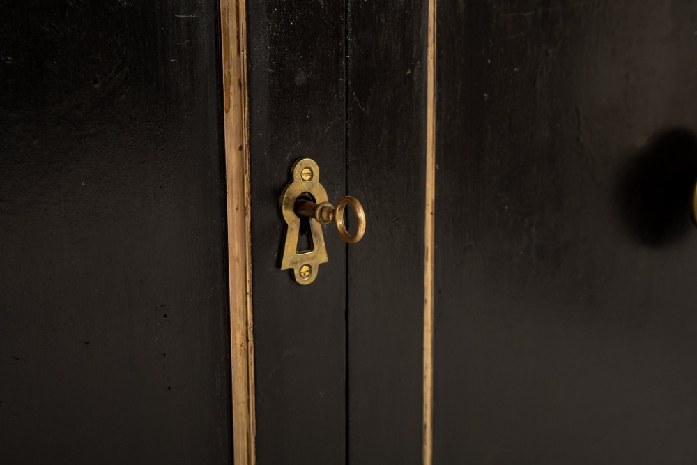 A pair of matching 18th-century Italian ebonised side cabinets featuring gilt metal mounts, fluted corner columns, single top drawers, and double panelled doors. View VI