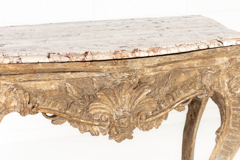 An 18th-century Italian Rococo silver-gilt console table featuring carved leaf motifs, cabriole legs, and a rectangular pink marble top. View II
