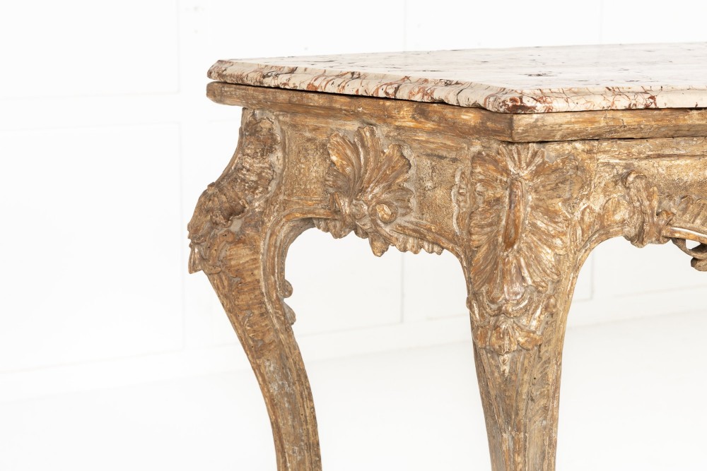 An 18th-century Italian Rococo silver-gilt console table featuring carved leaf motifs, cabriole legs, and a rectangular pink marble top. View III