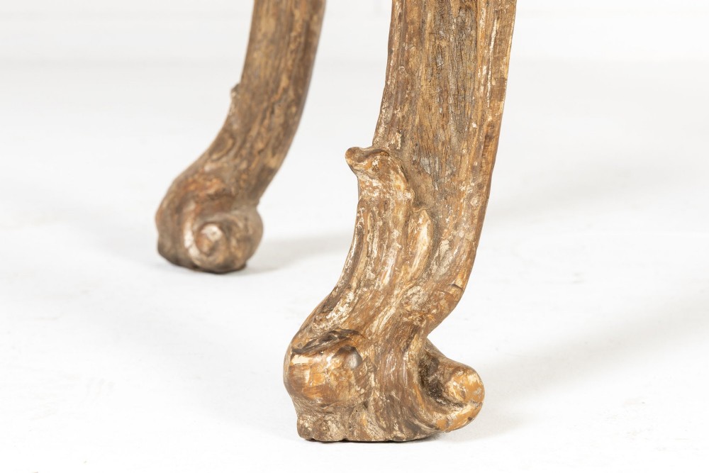 An 18th-century Italian Rococo silver-gilt console table featuring carved leaf motifs, cabriole legs, and a rectangular pink marble top. View VI