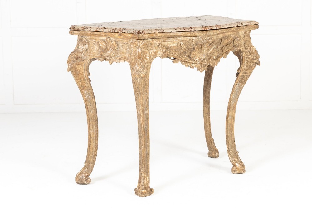 An 18th-century Italian Rococo silver-gilt console table featuring carved leaf motifs, cabriole legs, and a rectangular pink marble top. View X