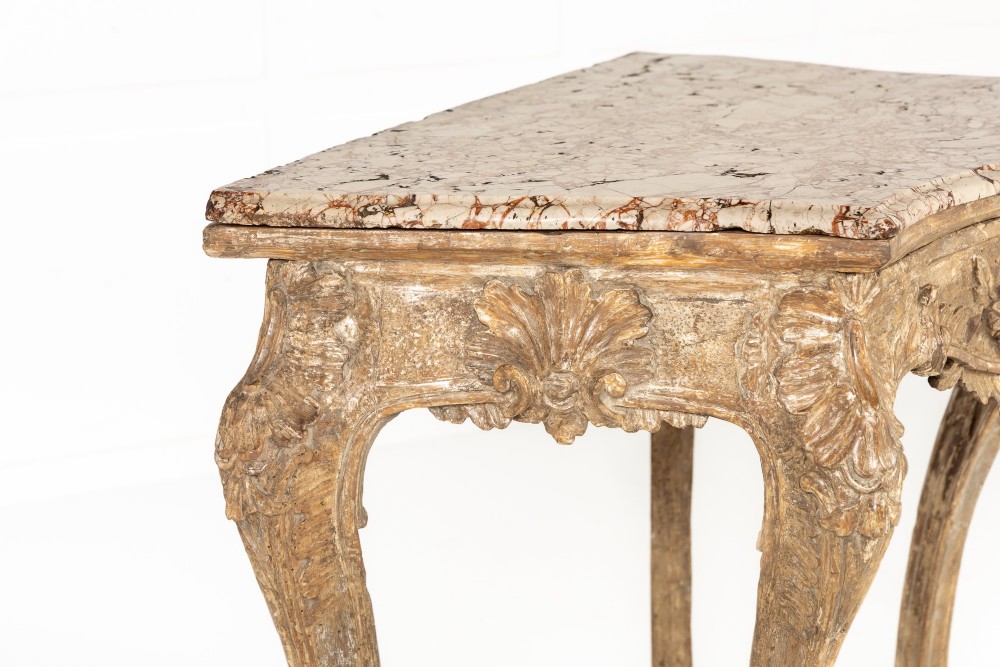 An 18th-century Italian Rococo silver-gilt console table featuring carved leaf motifs, cabriole legs, and a rectangular pink marble top. View XI